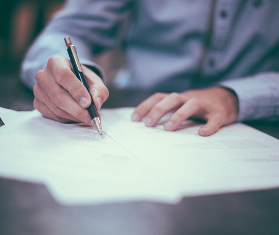 A professional signing payroll paperwork at a desk